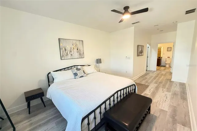 a bedroom with a bed a table and chair