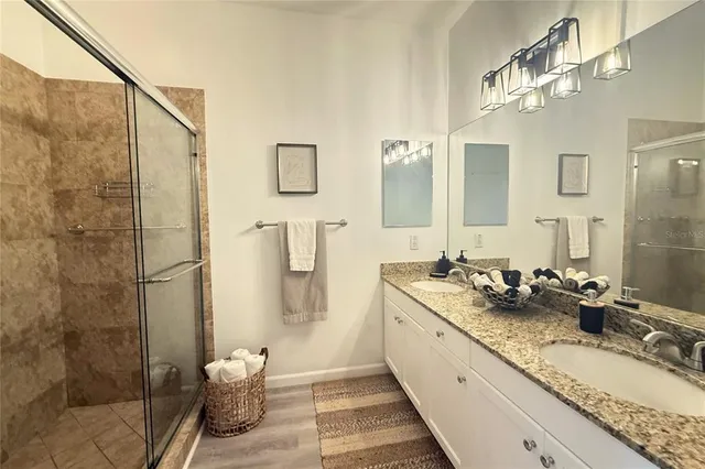 a spacious bathroom with a granite countertop sink and a mirror