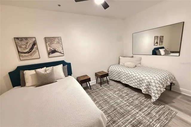 a bedroom with a bed and painting on the wall