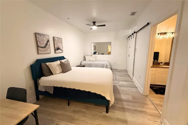 a spacious bedroom with a bed and a table