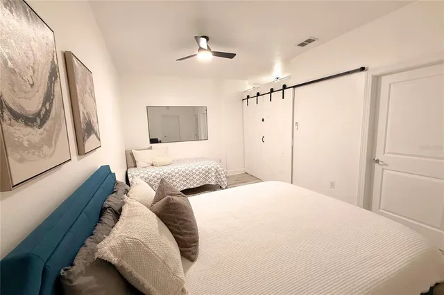 a bedroom with a bed and a painting on the wall