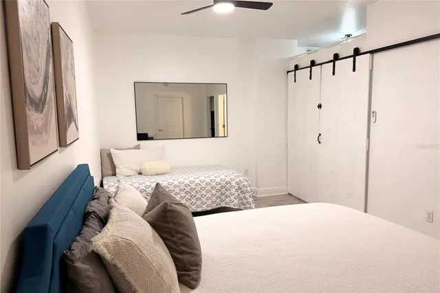 a bedroom with a bed and a chandelier