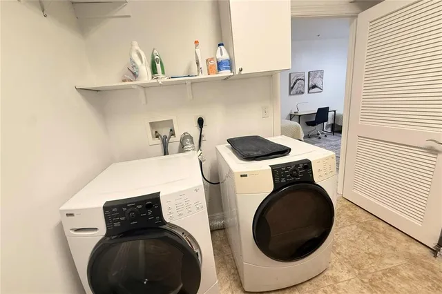 a utility room with sink dryer and washer