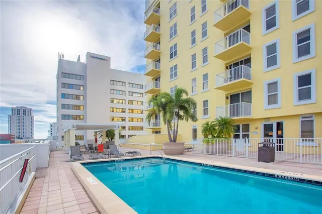 a swimming pool view with a outdoor seating