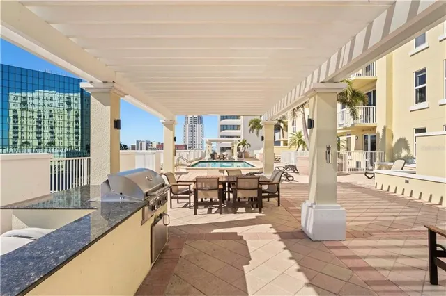 a dining hall with couches a coffee table and chairs