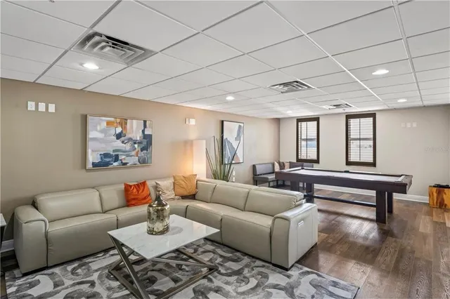 a living room with furniture a couch and wooden floor