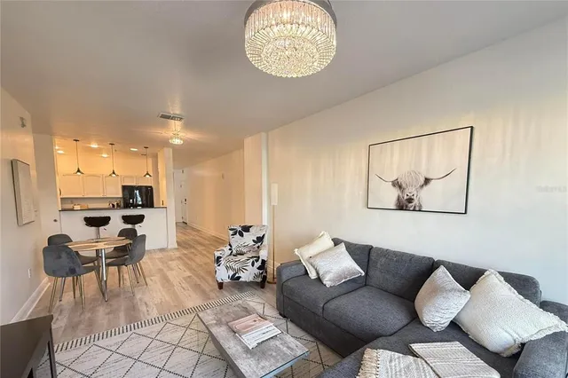 a living room with furniture a rug and white walls