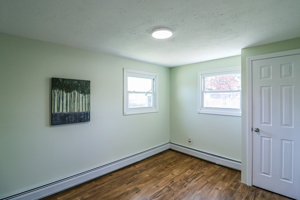1114 Allen Street Springfield, MA 01118 - Photo 14 of 25 an empty room with wooden floor and windows