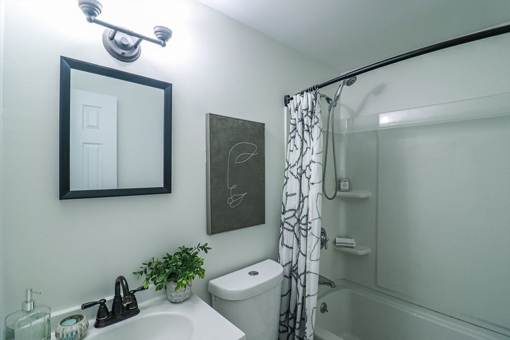 1114 Allen Street Springfield, MA 01118 - Photo 19 of 25 a bathroom with a sink a toilet and shower