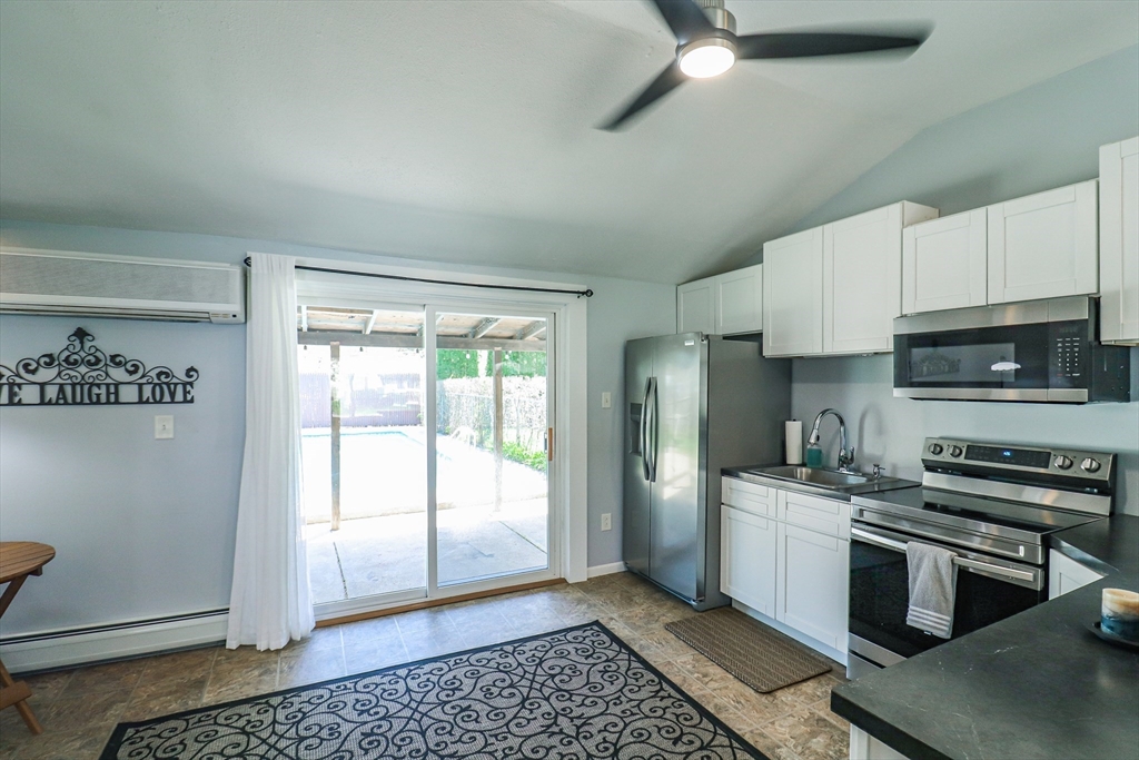 1114 Allen Street Springfield, MA 01118 - Photo 9 of 25 a kitchen with stainless steel appliances a refrigerator a sink a stove a microwave and cabinets