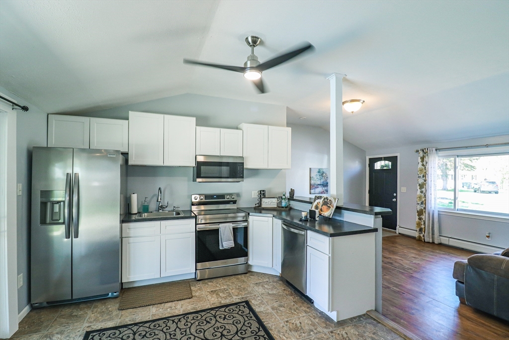 1114 Allen Street Springfield, MA 01118 - Photo 10 of 25 a kitchen with stainless steel appliances kitchen island granite countertop a refrigerator stove top oven and sink