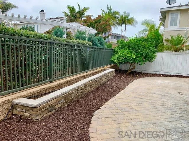 6921 Catamaran Drive Carlsbad, CA 92011 - Photo 16 of 26 a view of a backyard with plants and lake view