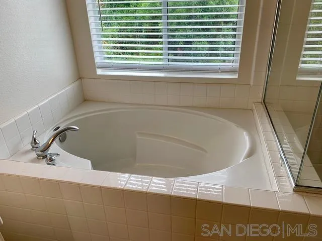 6921 Catamaran Drive Carlsbad, CA 92011 - Photo 6 of 26 a bathroom with a window