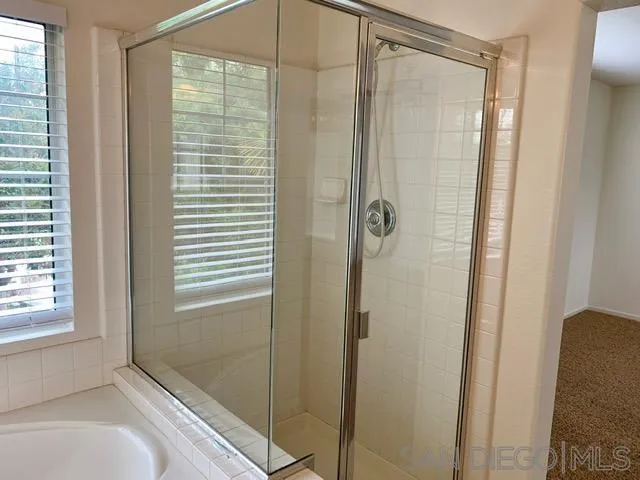 6921 Catamaran Drive Carlsbad, CA 92011 - Photo 7 of 26 a bathroom with a bathtub and shower