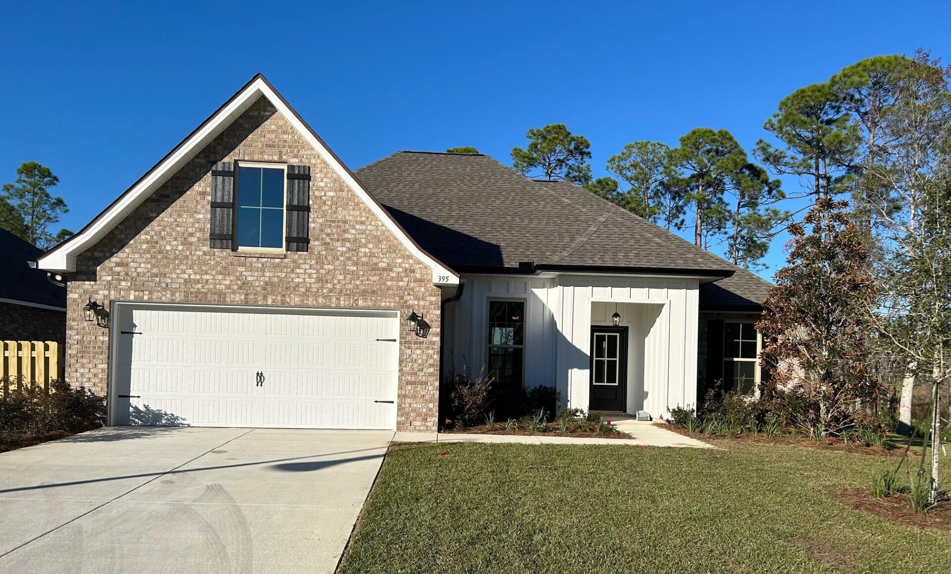 395 Constellation Avenue Freeport, FL 32439 - Photo 1 of 3 a front view of a house with a yard
