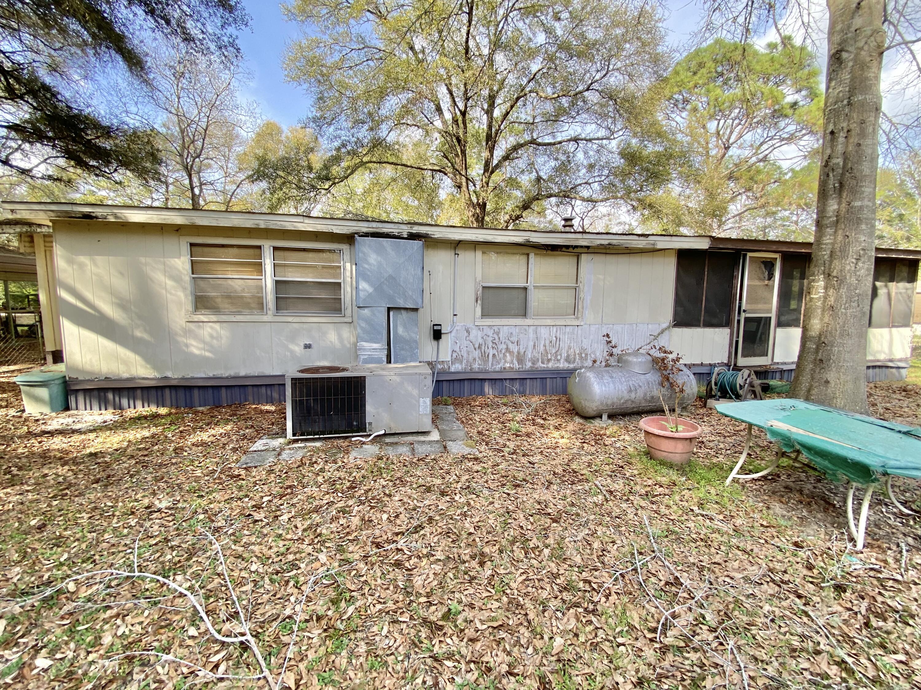 3210 Wells Avenue Crestview, FL 32539 - Photo 15 of 21 a backyard of a house with table and chairs