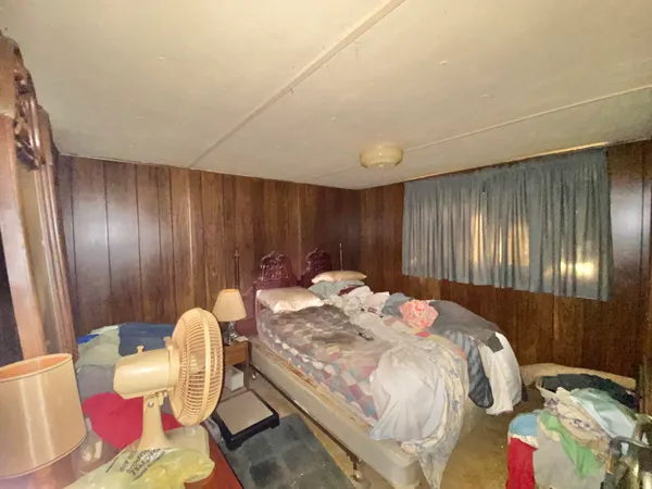 a bedroom with a bed and curtain