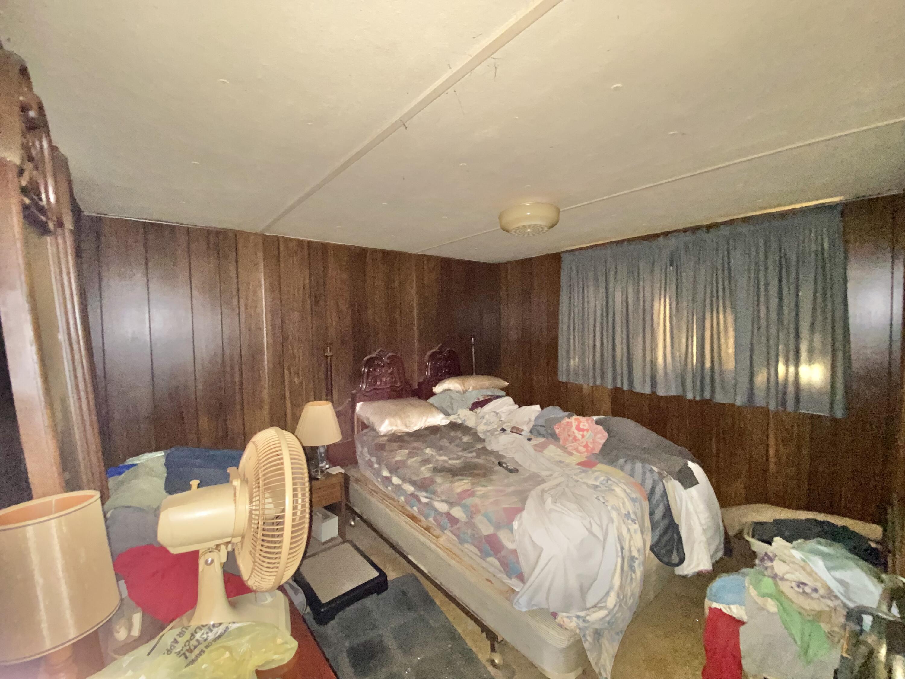 3210 Wells Avenue Crestview, FL 32539 - Photo 16 of 21 a bedroom with a bed and curtain