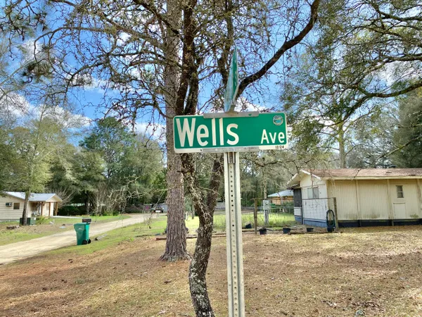 a street sign on a sidewalk next to a road