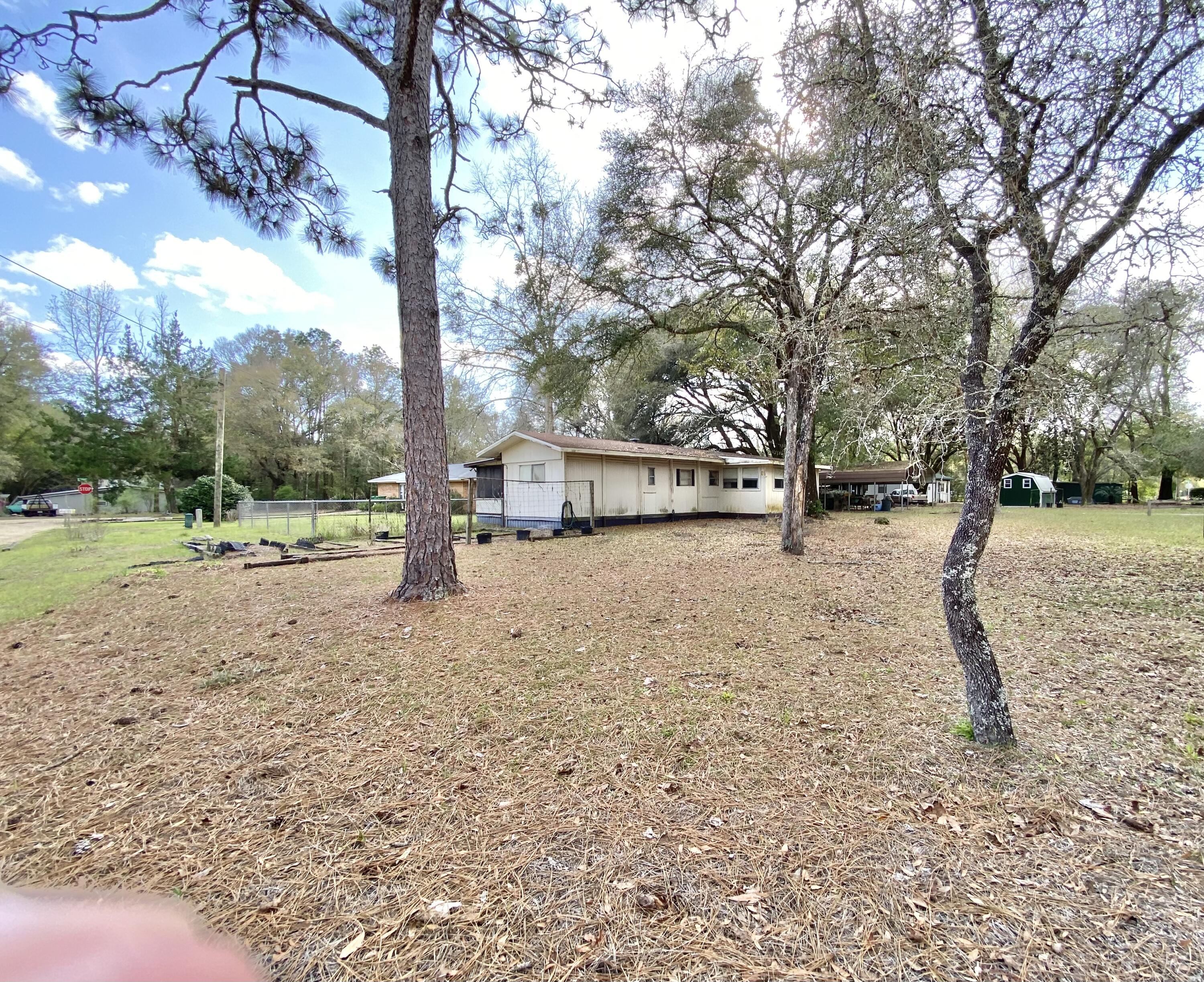 3210 Wells Avenue Crestview, FL 32539 - Photo 3 of 21 a view of outdoor space with trees