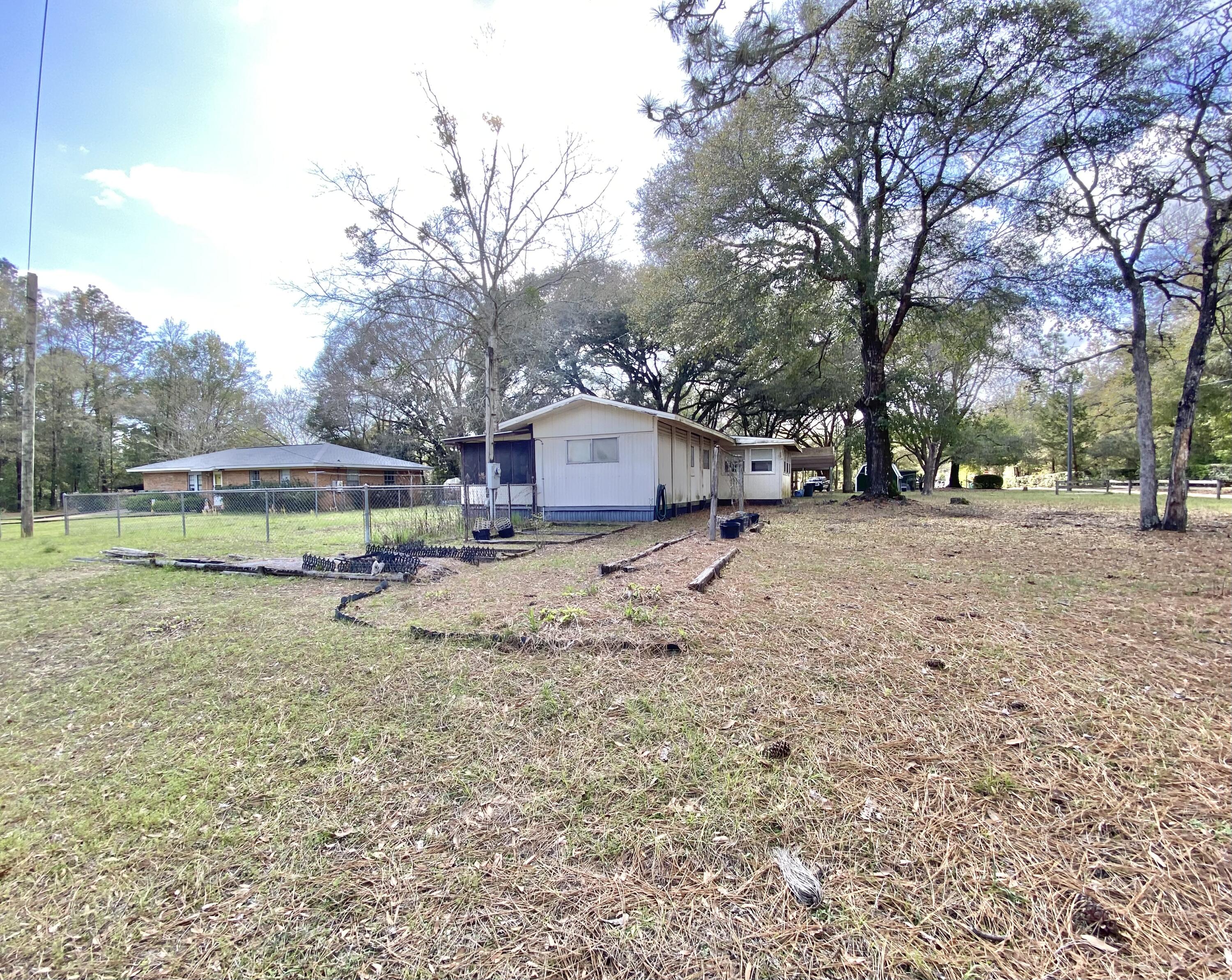 3210 Wells Avenue Crestview, FL 32539 - Photo 5 of 21 a view of a house with a yard covered in snow