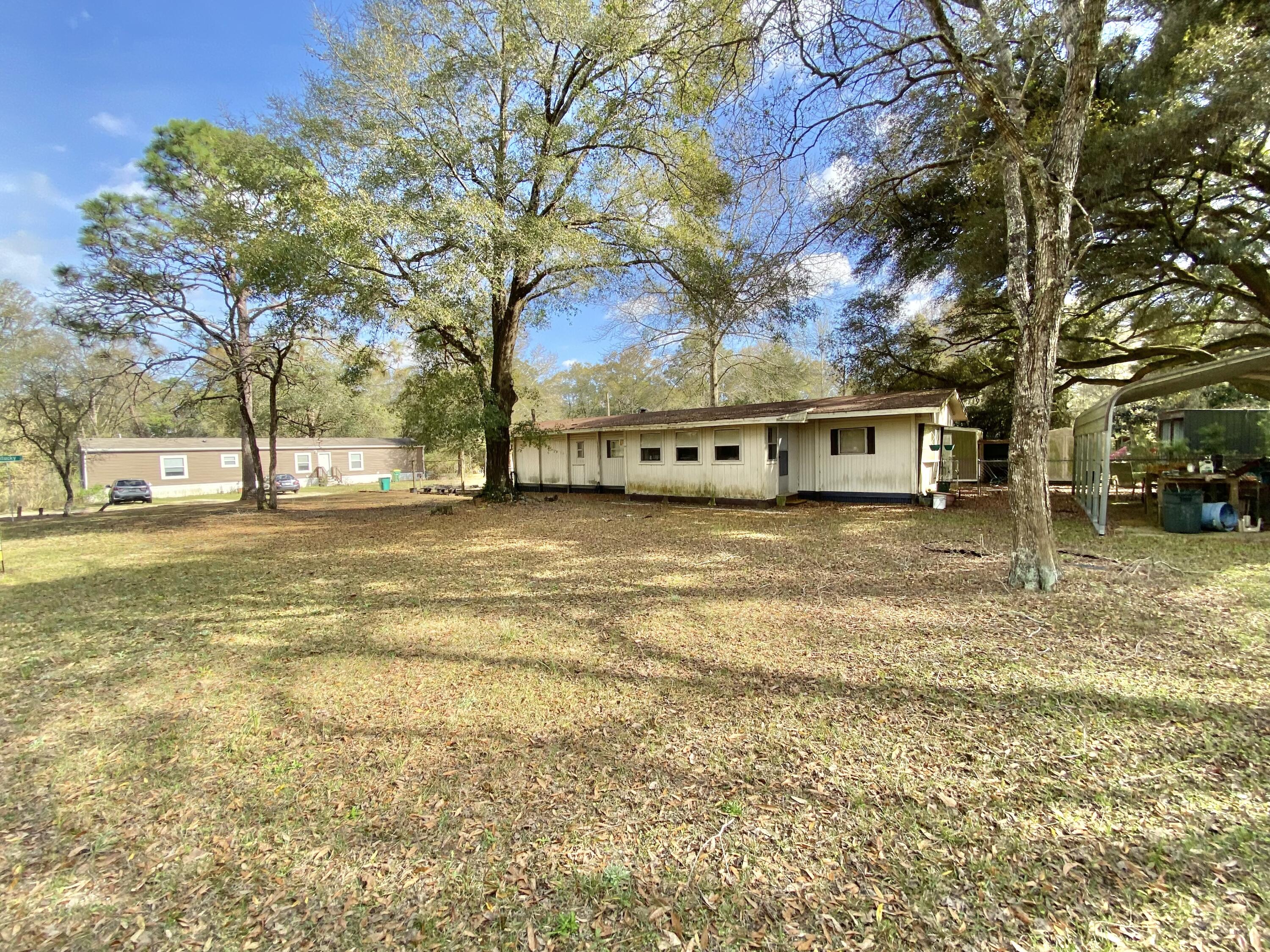 3210 Wells Avenue Crestview, FL 32539 - Photo 9 of 21 a view of a house with a yard and trees
