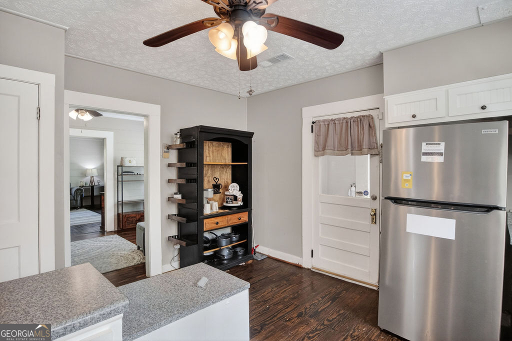 2051 Emmett Doster Road Northwest Monroe, GA 30656 - Photo 14 of 50 a kitchen with stainless steel appliances kitchen island granite countertop a refrigerator and a sink