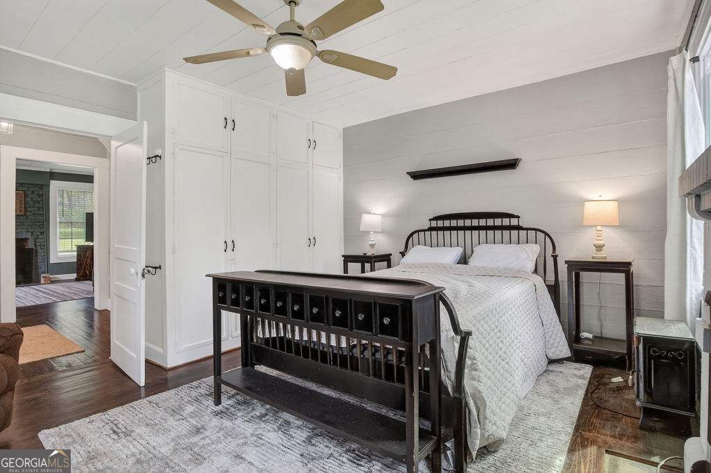 2051 Emmett Doster Road Northwest Monroe, GA 30656 - Photo 22 of 50 a bedroom with a bed and wooden floor