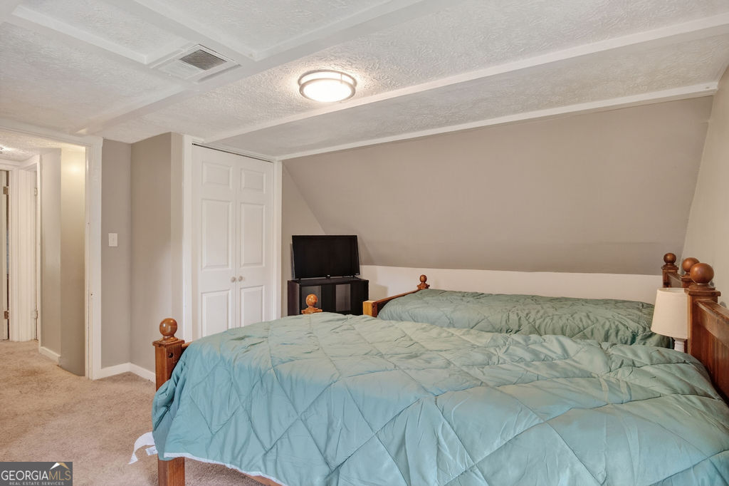 2051 Emmett Doster Road Northwest Monroe, GA 30656 - Photo 25 of 50 a bedroom with a bed and a tv on wall