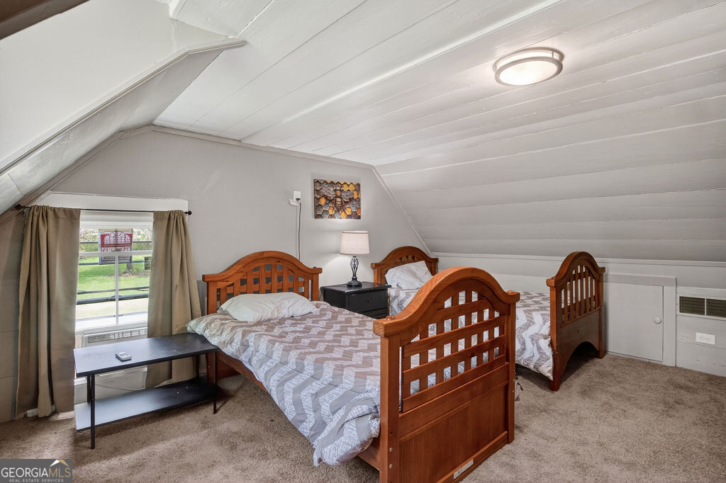 2051 Emmett Doster Road Northwest Monroe, GA 30656 - Photo 27 of 50 a bedroom with two beds and a dresser next to a window