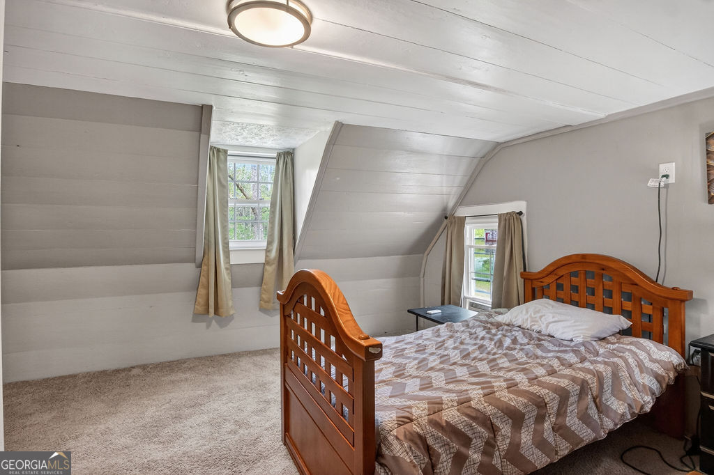 2051 Emmett Doster Road Northwest Monroe, GA 30656 - Photo 28 of 50 a bedroom with a bed lamp and window