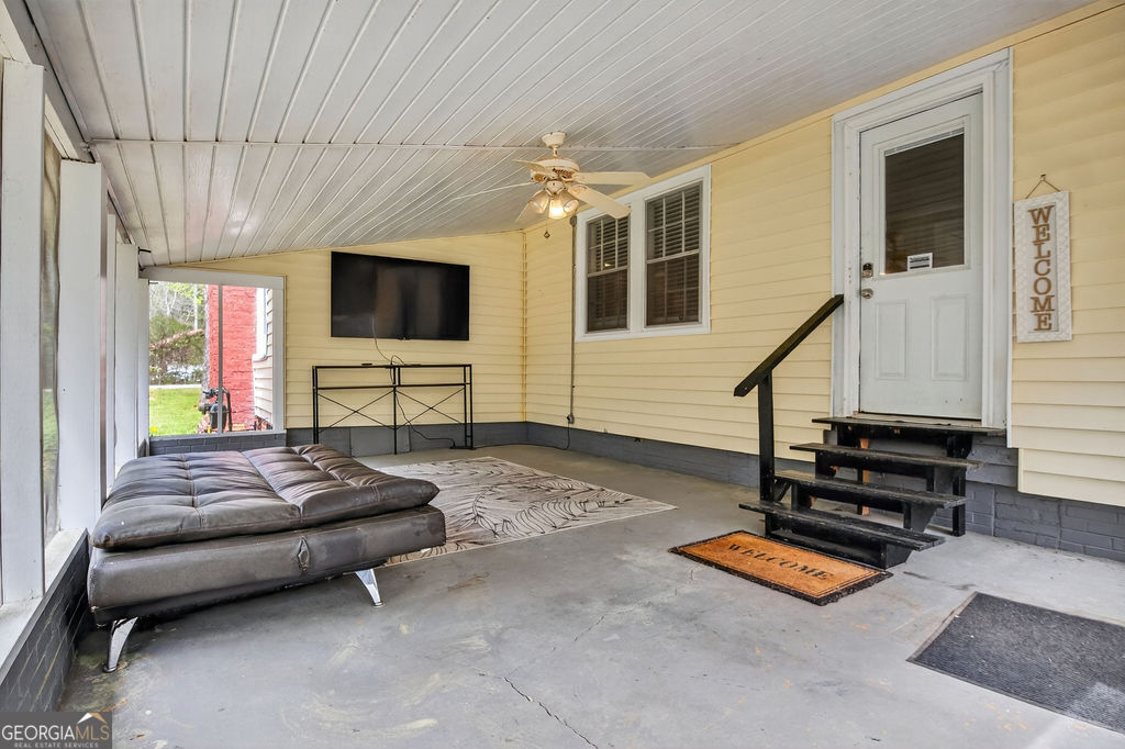 2051 Emmett Doster Road Northwest Monroe, GA 30656 - Photo 29 of 50 a living room with furniture a flat screen tv and a window