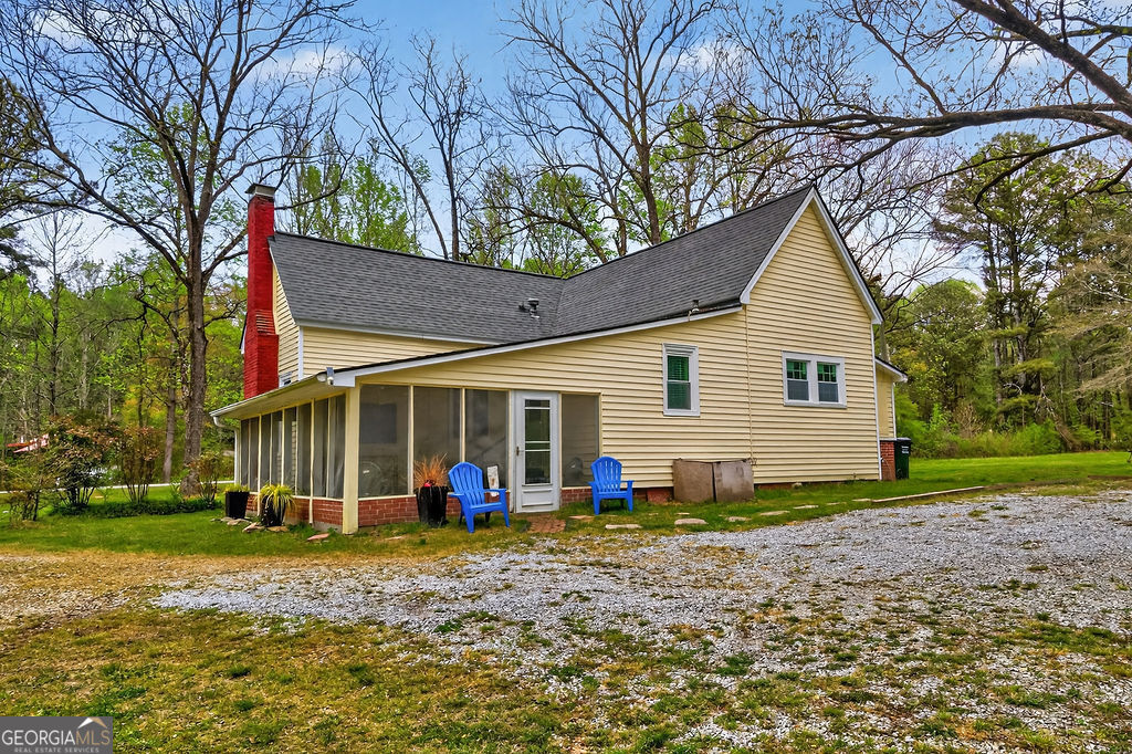 2051 Emmett Doster Road Northwest Monroe, GA 30656 - Photo 31 of 50 a view of a house with backyard and trees