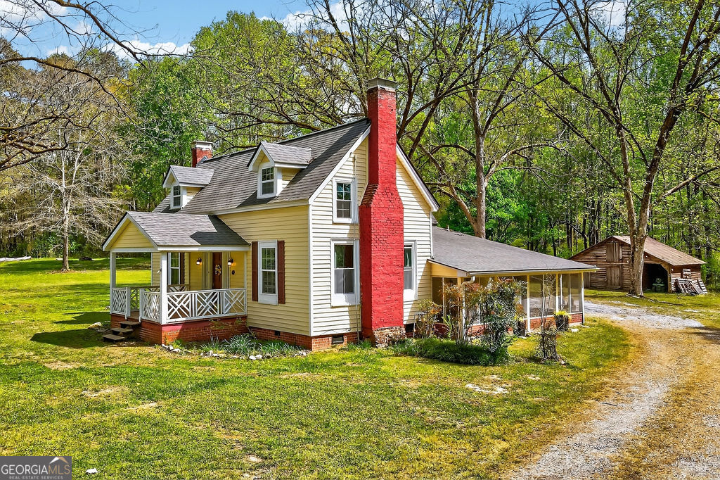 2051 Emmett Doster Road Northwest Monroe, GA 30656 - Photo 32 of 50 a front view of a house with garden