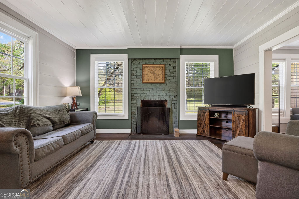 2051 Emmett Doster Road Northwest Monroe, GA 30656 - Photo 7 of 50 a living room with furniture and a flat screen tv