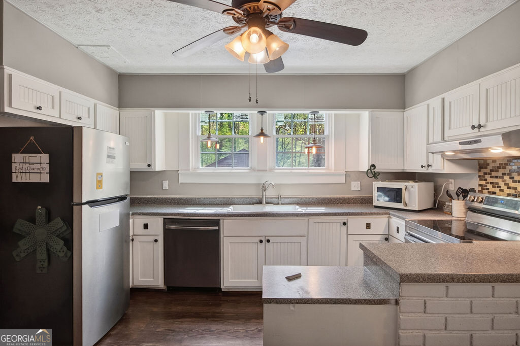 2051 Emmett Doster Road Northwest Monroe, GA 30656 - Photo 10 of 50 a kitchen with a sink stove and refrigerator
