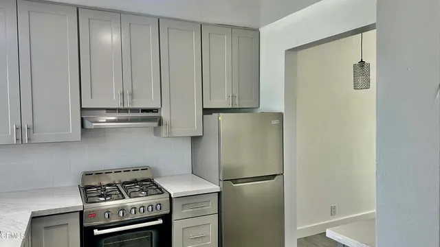 a kitchen with a refrigerator and cabinets