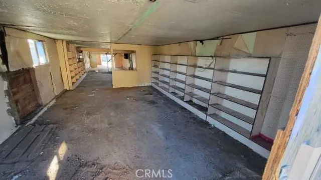 a view of an empty room with a fireplace