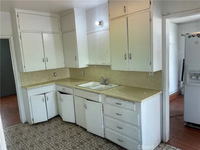 a kitchen with a sink and cabinets
