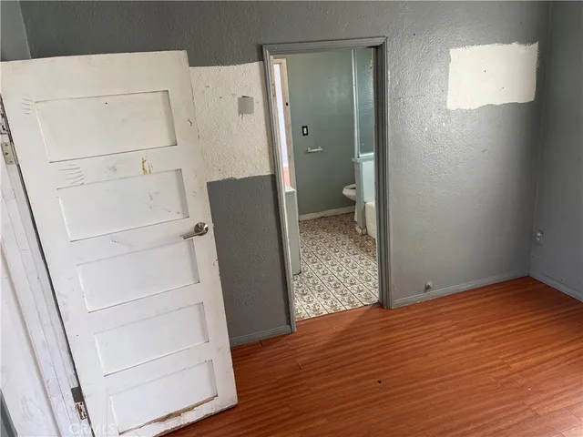 a view of walk in closet with wooden floor