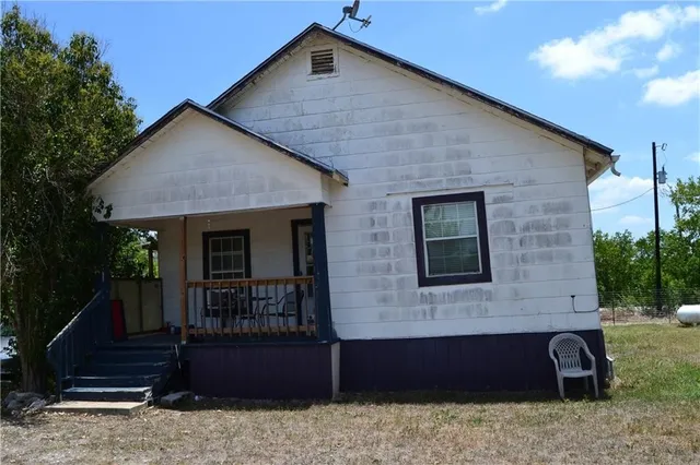 a view of a house with wooden fence