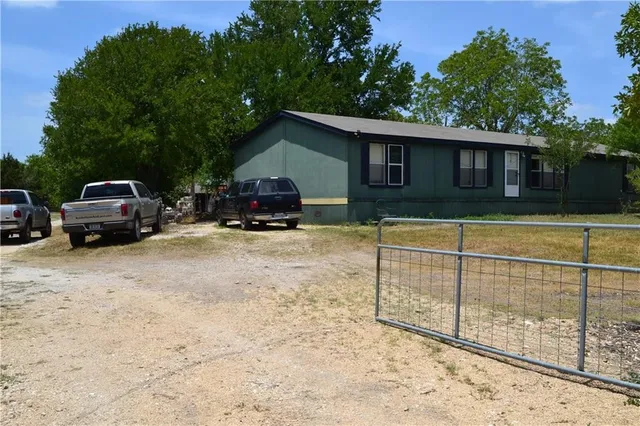a view of outdoor space with field and trees