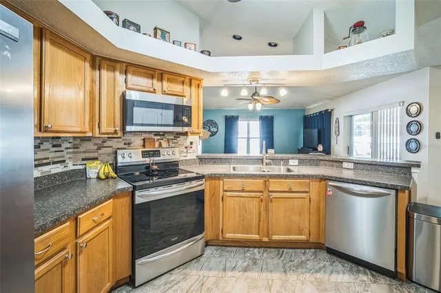 a living room with furniture a chandelier and a window