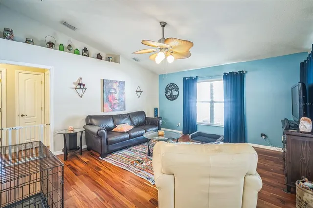 a living room with furniture a chandelier and a window
