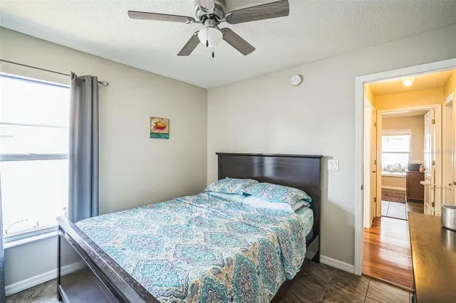 a bathroom with a granite countertop sink toilet and a mirror