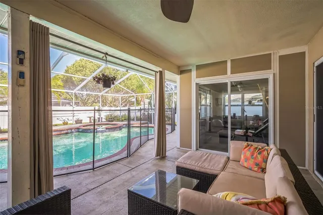 a living room with furniture a dining table and chairs with a large window
