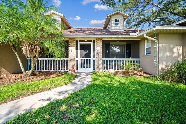 a front view of a house with a yard table and chairs