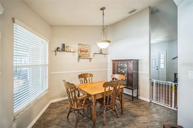 a bedroom with a bed a chandelier and mirror