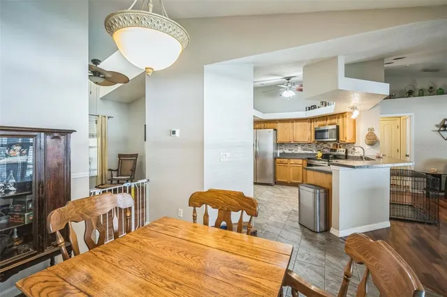 a large kitchen with stainless steel appliances granite countertop a stove refrigerator sink and dishwasher