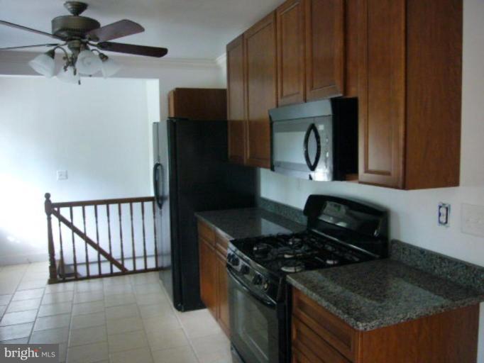 317 Worthington Road Towson, MD 21286 - Photo 2 of 14 a kitchen with granite countertop a stove and a refrigerator